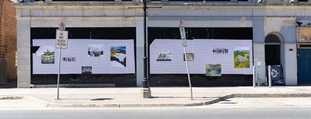 Landscape image of King St. near Scott St., where images are wheatpasted along black walled-off storefronts. The words say listen, protect / protest, have it your way. The images splice together natural beauty and industrial waste.