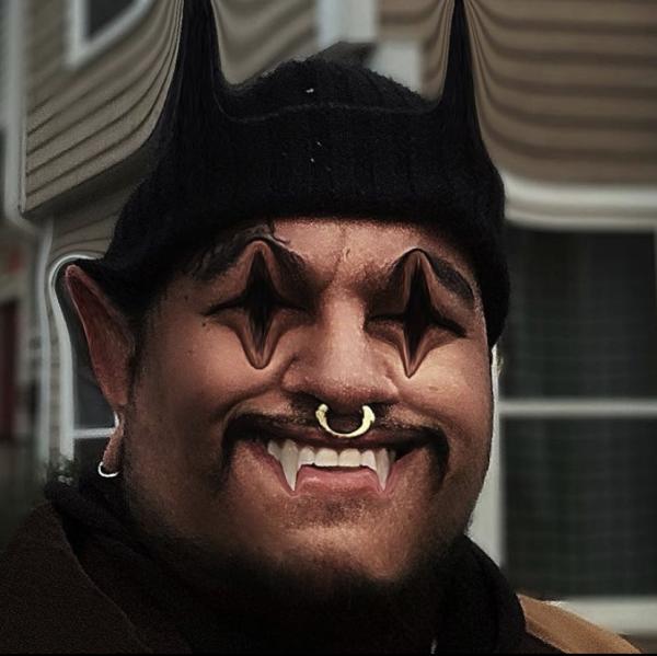 Image of a person with a silver nose-ring, their eyes, teeth, head, and ears are distorted into horn and fang-like points.