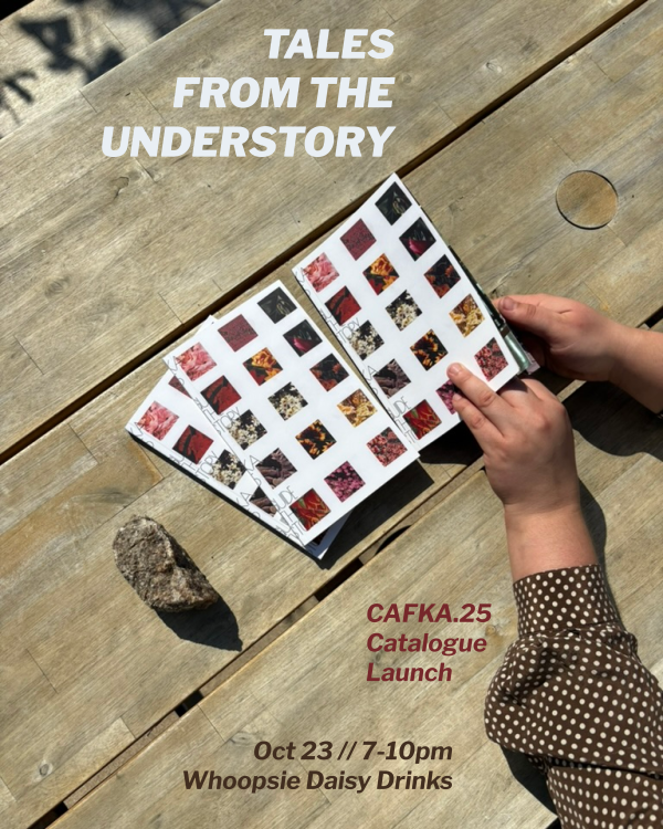 Hands emerging from the sleeves of a brown polka-dot blouse open the cover of a white book covered in floral tiles.